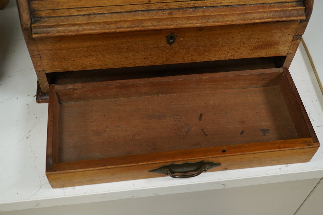 A Victorian mahogany stationery box with calendar and roll top, 34cm high